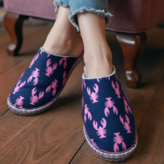 Woman wearing finished navy and pink lobster print WOOLIGANS DIY slippers on a hardwood floor